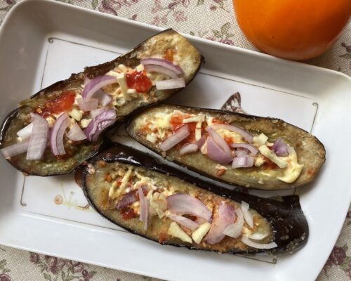 Savory Italian eggplant appetizer with garlic and onion garnish