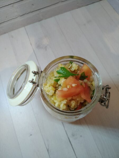 Light bulgur and herb salad garnished with olive oil and lemon