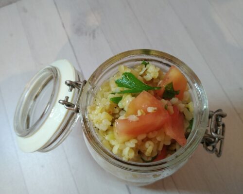 Light bulgur and herb salad garnished with olive oil and lemon