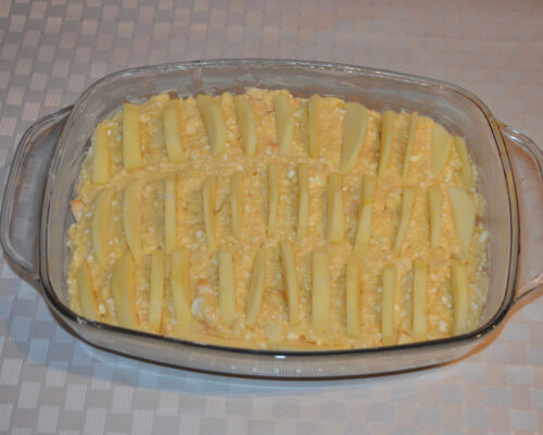 Sliced apple arranged on top of cottage cheese batter before baking