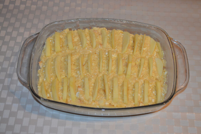 Sliced apple arranged on top of cottage cheese batter before baking