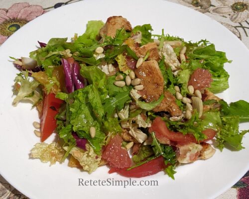 Colorful salad bowl with fruit, chicken and greens