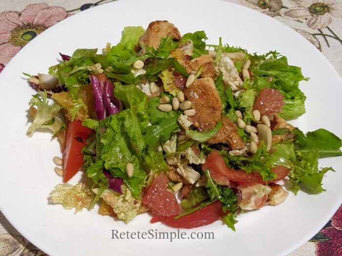 Colorful salad bowl with fruit, chicken and greens