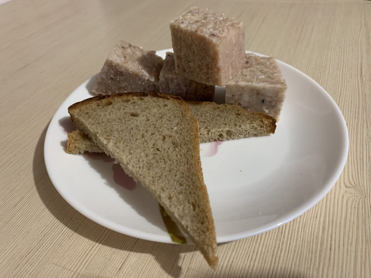 Slices of pork and chicken aspic (piftie) shimmering in a bowl
