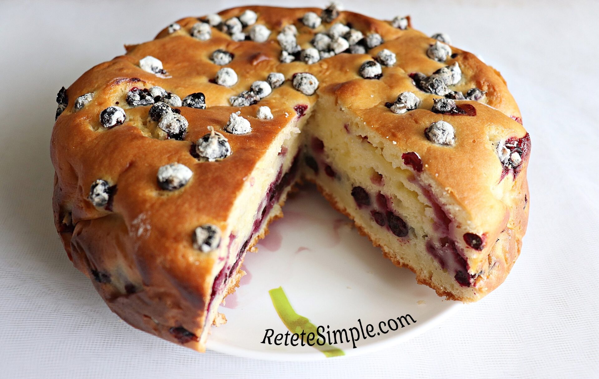 Fluffy sponge cake dotted with juicy blackcurrants
