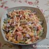 Colorful salad with cheese, cucumbers and crispy croutons in bowl
