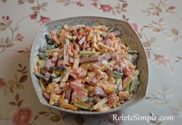Colorful salad with cheese, cucumbers and crispy croutons in bowl