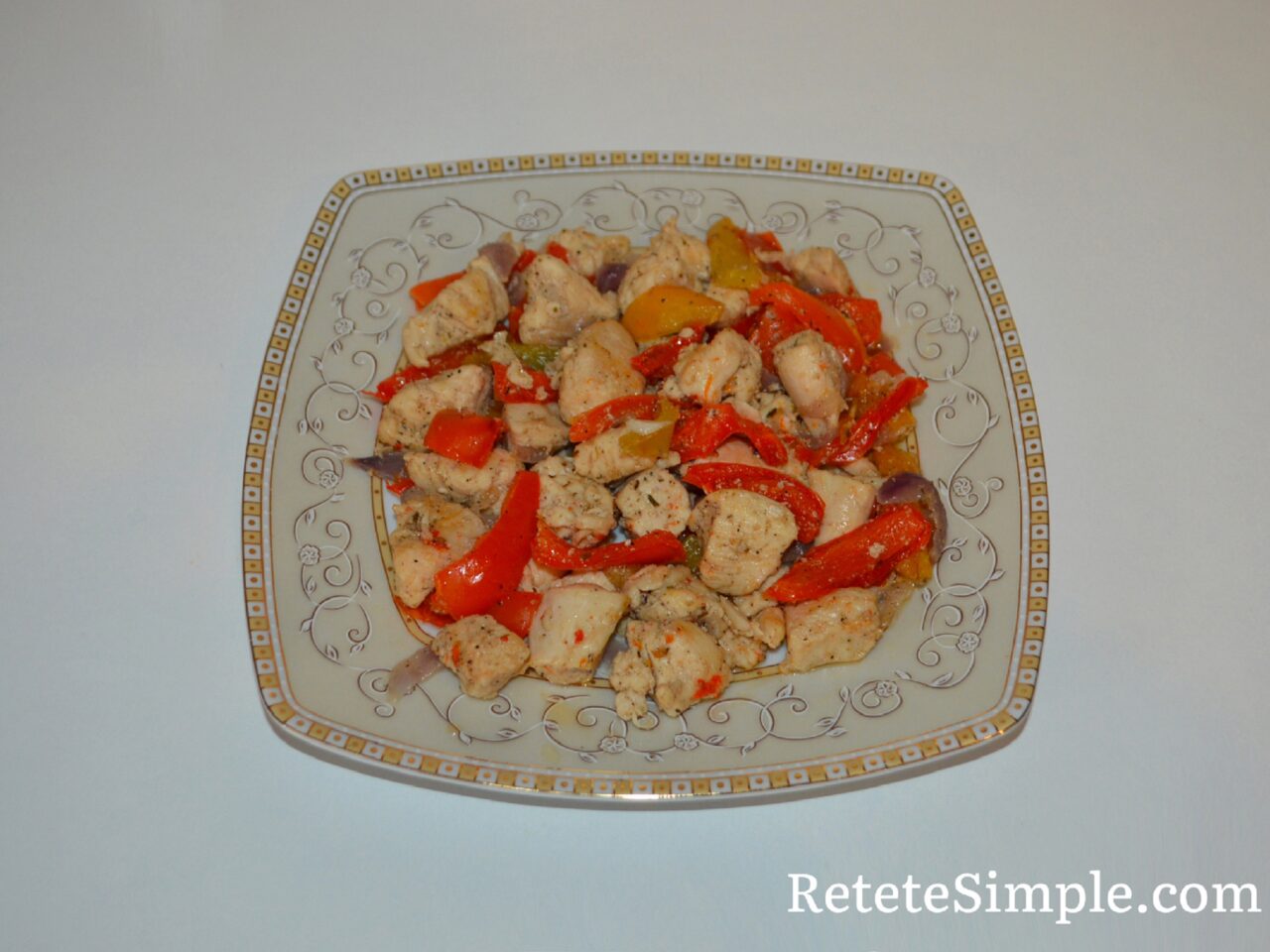 Juicy chicken pieces sautéed with peppers on plate