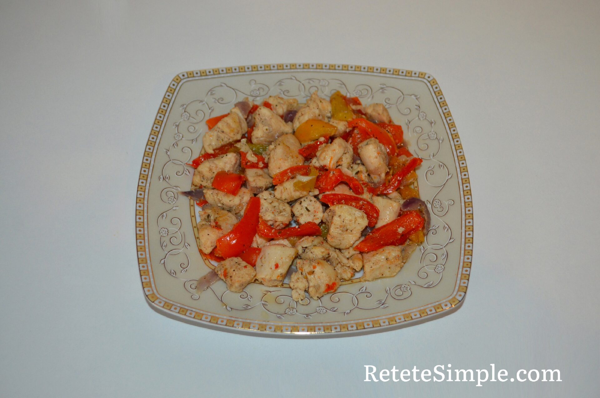 Juicy chicken pieces sautéed with peppers on plate