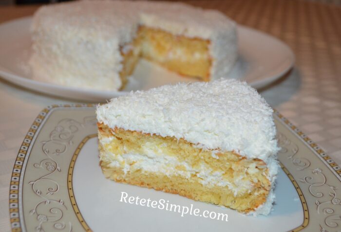 Slice of coconut cake showing creamy layers image