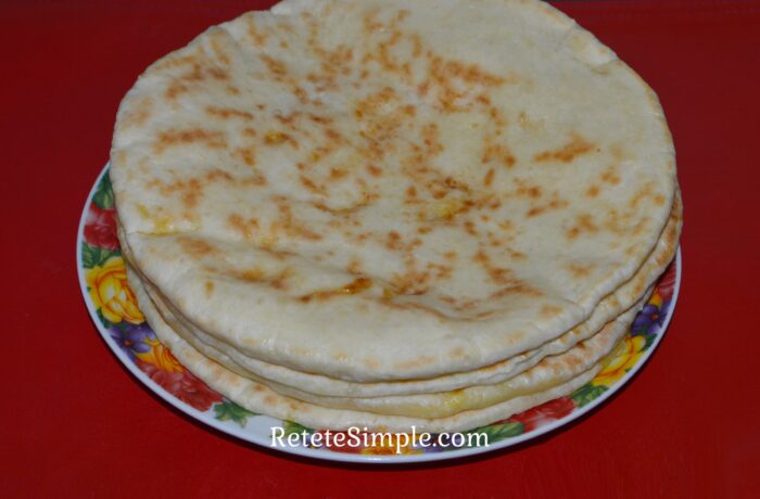 Golden pan-fried cheese turnovers on a plate