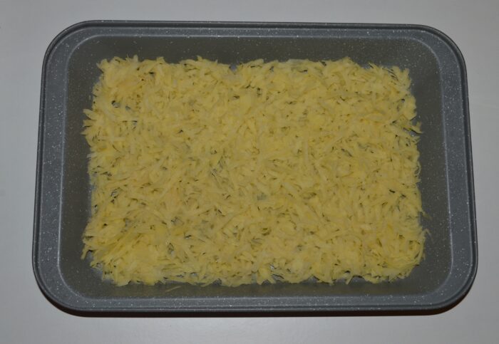 Peel the potatoes and grate