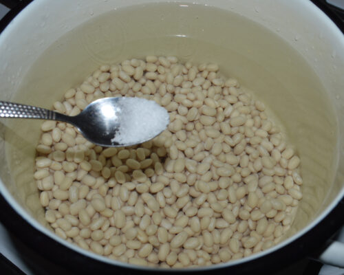 Pour the water into a saucepan and add the beans