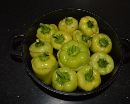 Place the cut tops over the stuffed peppers