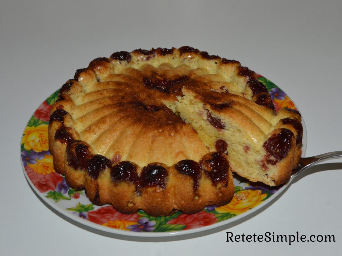 Tender fluffy cake with cherry fruit visible in slice