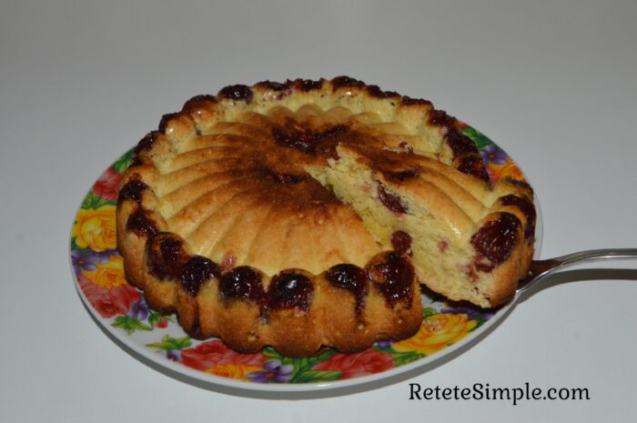 Tender fluffy cake with cherry fruit visible in slice