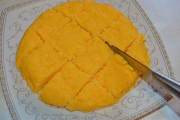 Cut the Moldovan mamaliga and serve