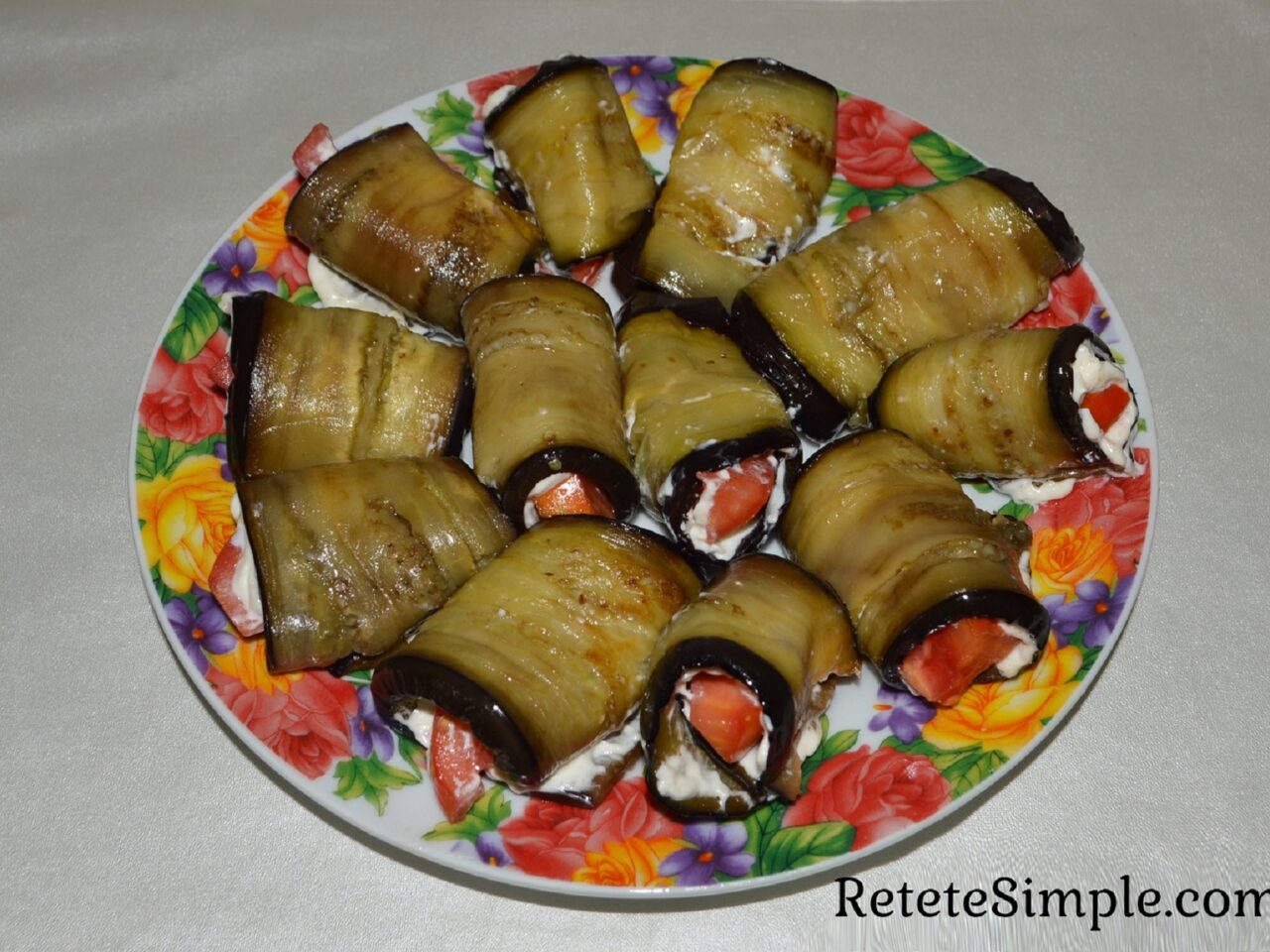 Close-up of creamy garlic-mayo eggplant roll with tomato