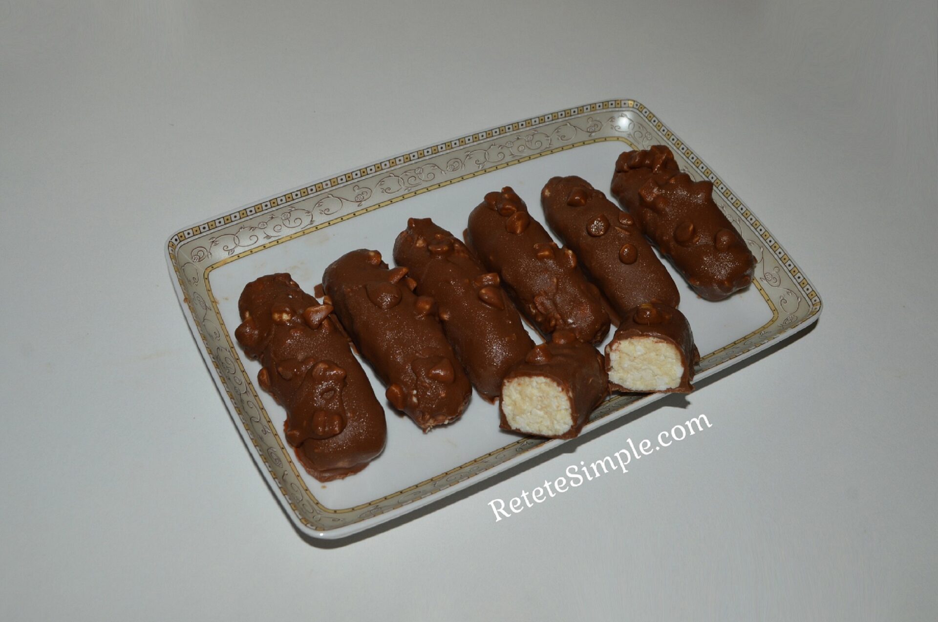 Close-up of chocolate-coated curd cheese bar with hazelnuts
