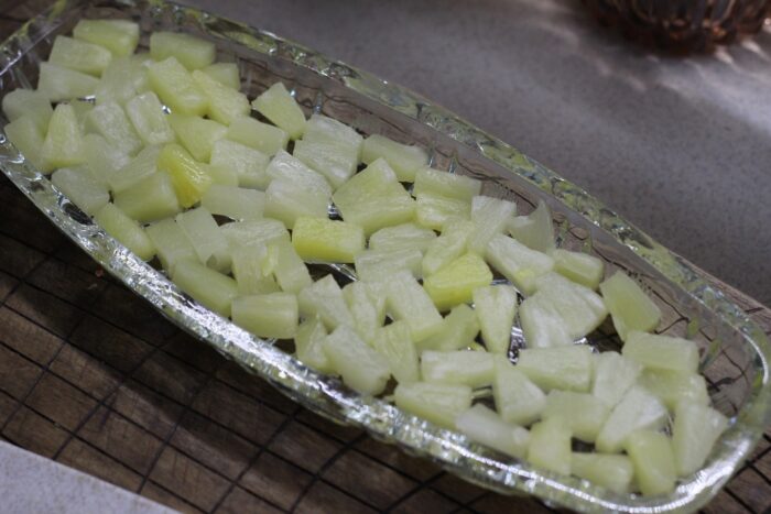 pineapple should be finely chopped and placed in a salad bowl