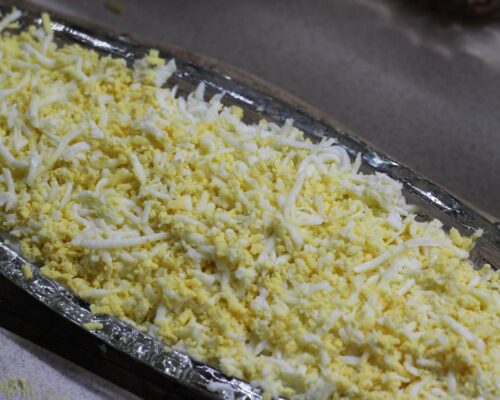 Add the grated eggs