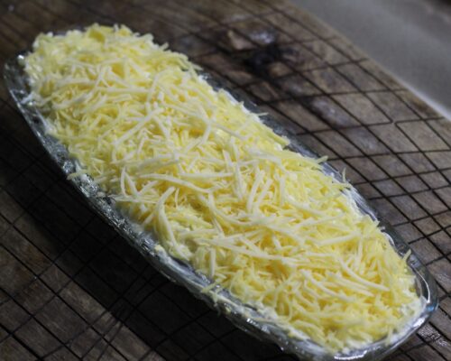 Spread a thin layer of grated cheese