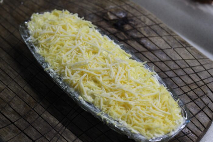 Spread a thin layer of grated cheese