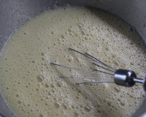 Add the condensed milk and cooled melted butter to the egg