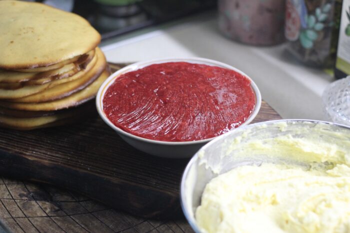 Assemble the cake by spreading the cream on the cakes