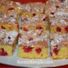 Slice of light cherry sponge cake with powdered sugar
