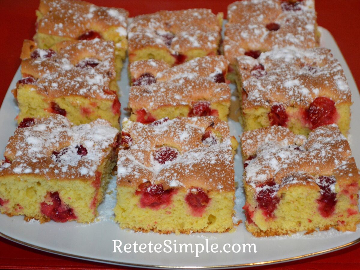 Slice of light cherry sponge cake with powdered sugar