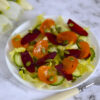 Persimmon avocado beet salad in white bowl
