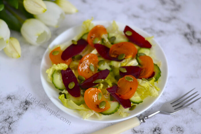 Persimmon avocado beet salad in white bowl