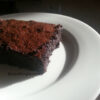 Gluten-free flourless chocolate cake slice on a plate