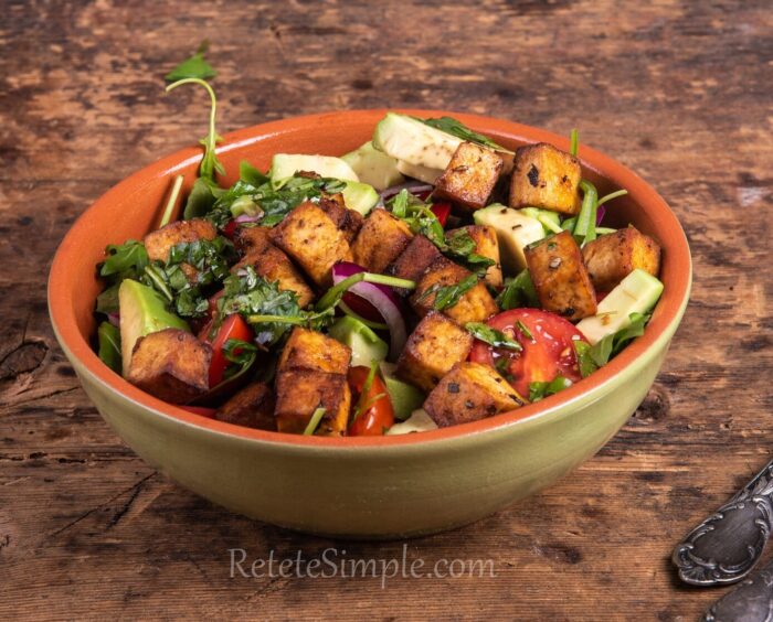 Close-up of avocado tofu salad with cherry tomatoes and bell peppers