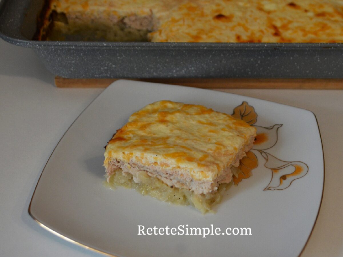 Slice of layered potato, chicken and cheese bake on a plate
