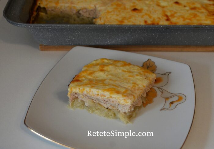 Slice of layered potato, chicken and cheese bake on a plate