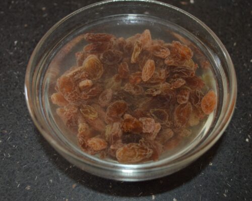 Pour boiling water over the raisins