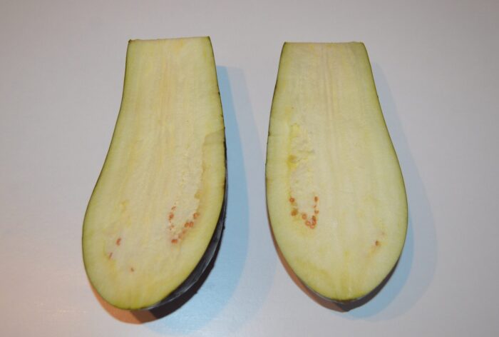 Wash the eggplant and cut it in half