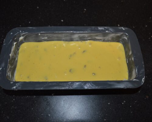 Pour the mixture into a buttered loaf pan