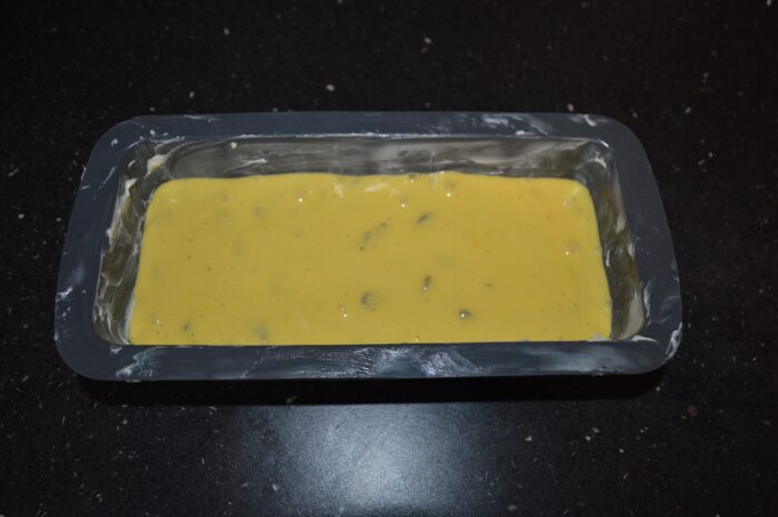Pour the mixture into a buttered loaf pan