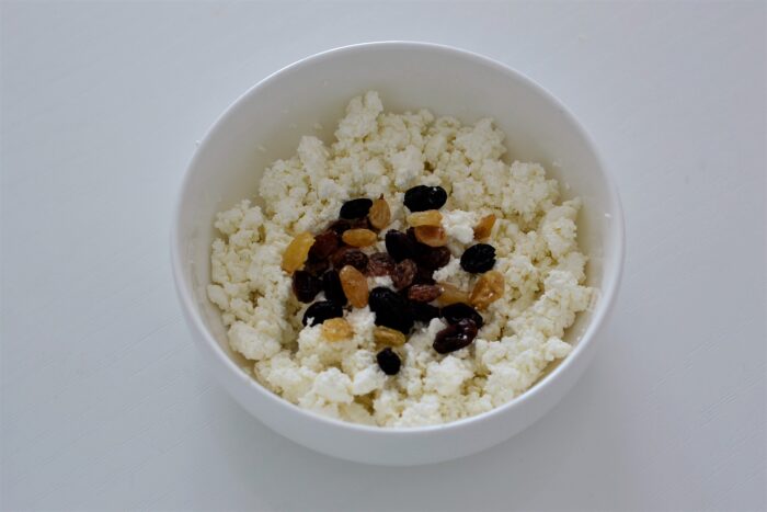 Добавляем распаренный и промытый изюм