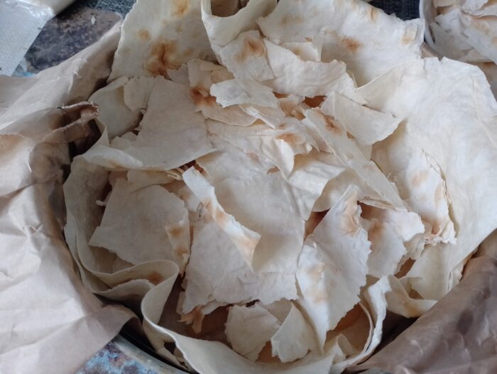Cover the pie with the remaining large pieces of lavash