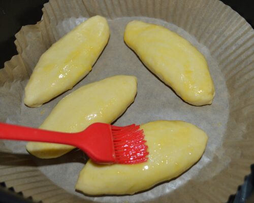 Grease the pastries with beaten egg