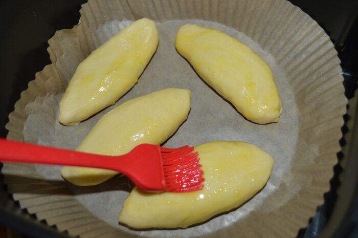 Grease the pastries with beaten egg