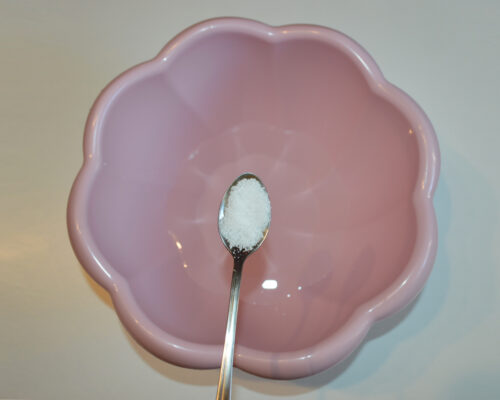 Pour warm water into a bowl and add salt