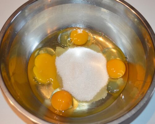 Break the eggs into a bowl and add the sugar