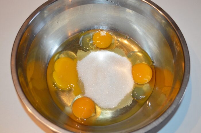 Break the eggs into a bowl and add the sugar