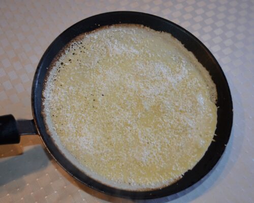 Sprinkle the grated coconut over the surface