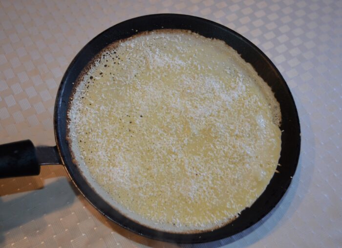 Sprinkle the grated coconut over the surface